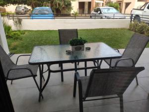 a table and chairs on a patio with a plant on it at Family house in Ofrínion