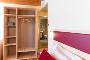 a room with a bed and a closet at Hotel Autoespresso Venice - Atika & Atif in Marghera
