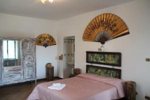 a bedroom with a bed and two large windows at Antica Dimora del Portico in Borgiallo