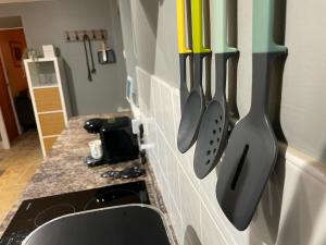a kitchen with knives hanging on a wall at Muddy Paws Cottages - The Nook in Taddington