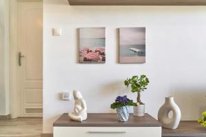 a living room with three pictures on the wall at Abierto al mar in Morche