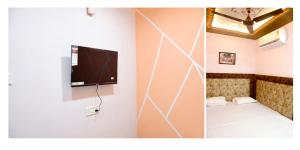 sun guest house في اوجاين: غرفة مع تلفزيون بشاشة مسطحة على الحائط