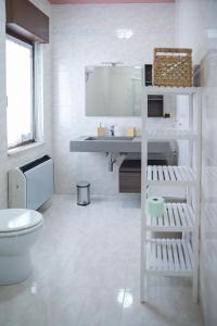 a white bathroom with a sink and a toilet at B&b Apartment 1970 in Lauria Inferiore