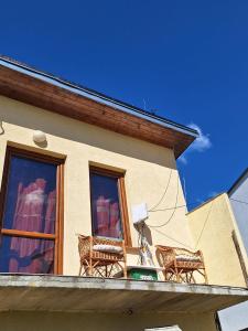 a building with two chairs on a balcony at Sunset House Piestany Bungalow in Banka