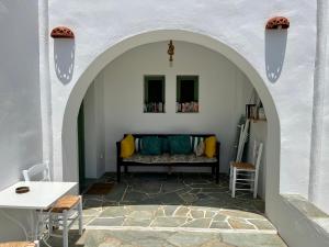 a living room with a couch under an archway at La Maison de Lilac-Luxurious Olive Grove apartments in Platis Gialos