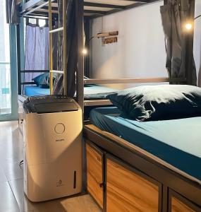 a room with two bunk beds and a dryer in it at JOY HOSTEL in Ho Chi Minh City