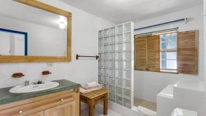 uma casa de banho com um lavatório, um WC e um espelho. em Edwards Guesthouse em Sandy Ground Village