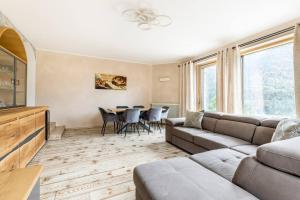 ein Wohnzimmer mit einem Sofa und einem Tisch in der Unterkunft Villa In Montagna - Caldes - Val Di Sole in Caldes