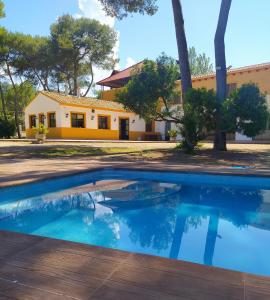 a swimming pool in front of a house at Hotel Casa Rural y Eventos Bonestar in Villalonga