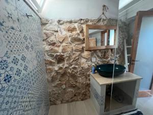 a stone bathroom with a sink and a mirror at Trulli delle succulente in Capilungo +54 photos