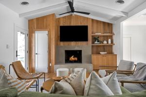 a living room with a couch and a fireplace at Mojito Haus with Hot tub in Fredericksburg