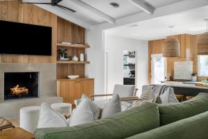 a living room with a couch and a fireplace at Mojito Haus with Hot tub in Fredericksburg +45 photos