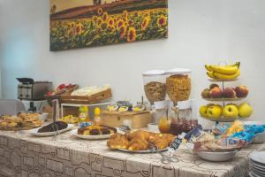 a table filled with food and fruits and vegetables at Podere San Filippo B&B-Apartment-Pet Friendly in Bibbona