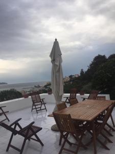a patio with a table and an umbrella at L'Isolana Case Vacanza Villa Alessia in Ponza