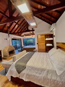 a bedroom with a large bed and a fireplace at Recanto das Cachoeiras in Angelina