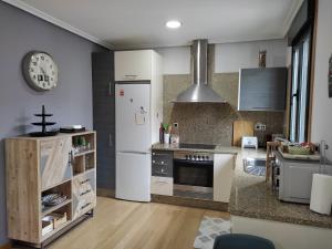 a kitchen with a white refrigerator and a counter at Home Barbaña in Ourense