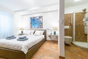 a bedroom with a large bed and a shower at Villa Bellavista II in Portorož