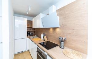 a kitchen with white cabinets and a counter top at Holiday Home Jadrija Vii Iii in Jadrija