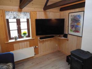 a living room with a flat screen tv on the wall at A pearl in the middle of Kvívík with a nice view in Kvívík
