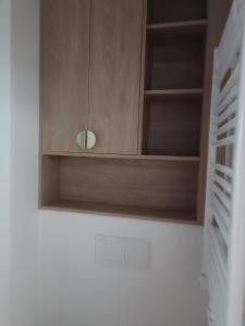 a wooden cupboard in a kitchen with a wall at Bel Mare Aqua 2 and Garden F104 in Międzyzdroje