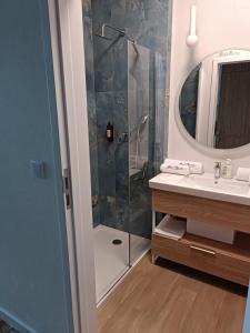 a bathroom with a shower and a sink and a mirror at Bel Mare Aqua 2 and Garden F104 in Międzyzdroje