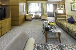 a living room with a couch and a table at Xijiao State Guest Hotel in Shanghai