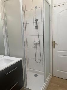 a shower with a glass door in a bathroom at Les jardins de Beauverger in Le Mans