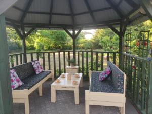 two chairs and a table on a gazebo at Domek i pokoje Wilkasy in Wilkasy +62 photos