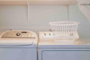 a washing machine and a bird cage sitting on a counter at Cozy 3Bdr home in the heart of Tampa in Tampa