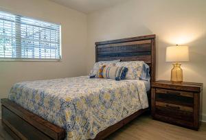 een slaapkamer met een bed, een lamp en een raam bij Cozy 3Bdr home in the heart of Tampa in Tampa
