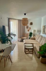 a living room with a couch and a table at Villa Bruno con vistas al mar, primera línea de playa in El Cotillo