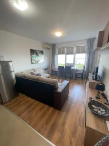 a living room with a couch and a table at Byla Sun Day Apartament in Byala