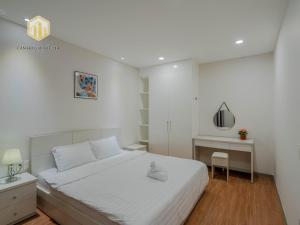 a white bedroom with a bed and a desk at Cozy Apartment, City Center , The Goldview D4 in Ho Chi Minh City