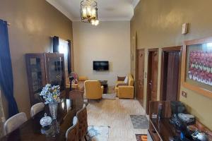 a room with a dining table and a living room at Sweet home 1 in Mansoura