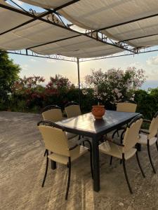 a table and chairs under an umbrella on a patio at Casa vacanze Piedigrotta in Pizzo