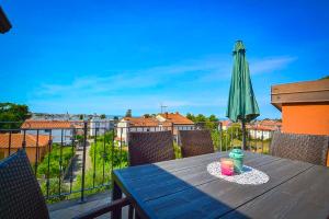 a blue table with a drink on a plate with a umbrella at Panorama Punta in Umag
