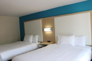 Voodi või voodid majutusasutuse Sunbird Cape Cod Annex toas
