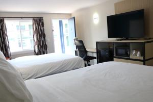Voodi või voodid majutusasutuse Sunbird Cape Cod Annex toas