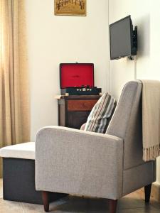 a living room with a couch and a tv at Charming Cottage Novo Čiče in Novo Čiče