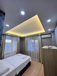 a bedroom with a bed and a large ceiling at New Armila Suites in Trabzon