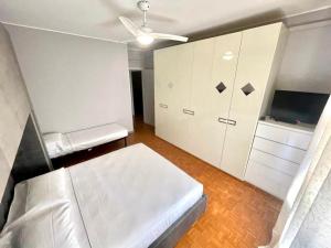 a bedroom with a white bed and a white cabinet at THE APARTMENT - HOME in Gerenzano +22 photos