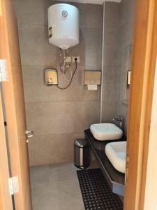 a bathroom with two toilets and a light on the wall at LA vista topaz in Ain Sokhna