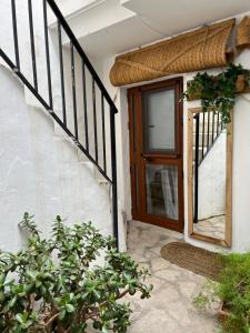 a house with a wooden door and a staircase at Tarifa the Life, acogedor estudio centro histórico in Tarifa