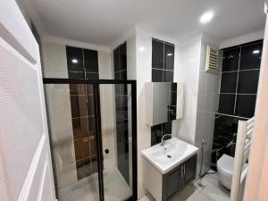 a bathroom with a shower and a sink and a toilet at New Armila Suites in Trabzon +31 photos