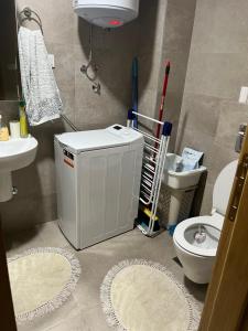 a bathroom with a toilet and a sink at Apartman Jakov in Bečići