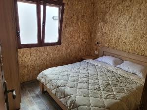 a bedroom with a bed and a window in it at Bungalovi Arabela in Utjeha