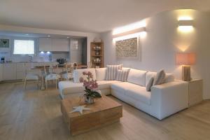 a living room with a white couch and a table at Summer Luxury Apartment Adults Only in Olbia