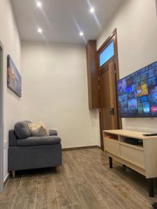 a living room with a couch and a flat screen tv at San Giuliani Heights in St. Julianʼs