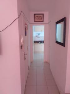 a hallway with pink walls and a sign on the wall at Appartement Fès in Fez