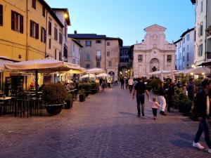 a group of people walking down a street at Visiale guest house in Spoleto